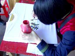 写真２０：Ｔシャツにトンパ文字を書いているところ。
